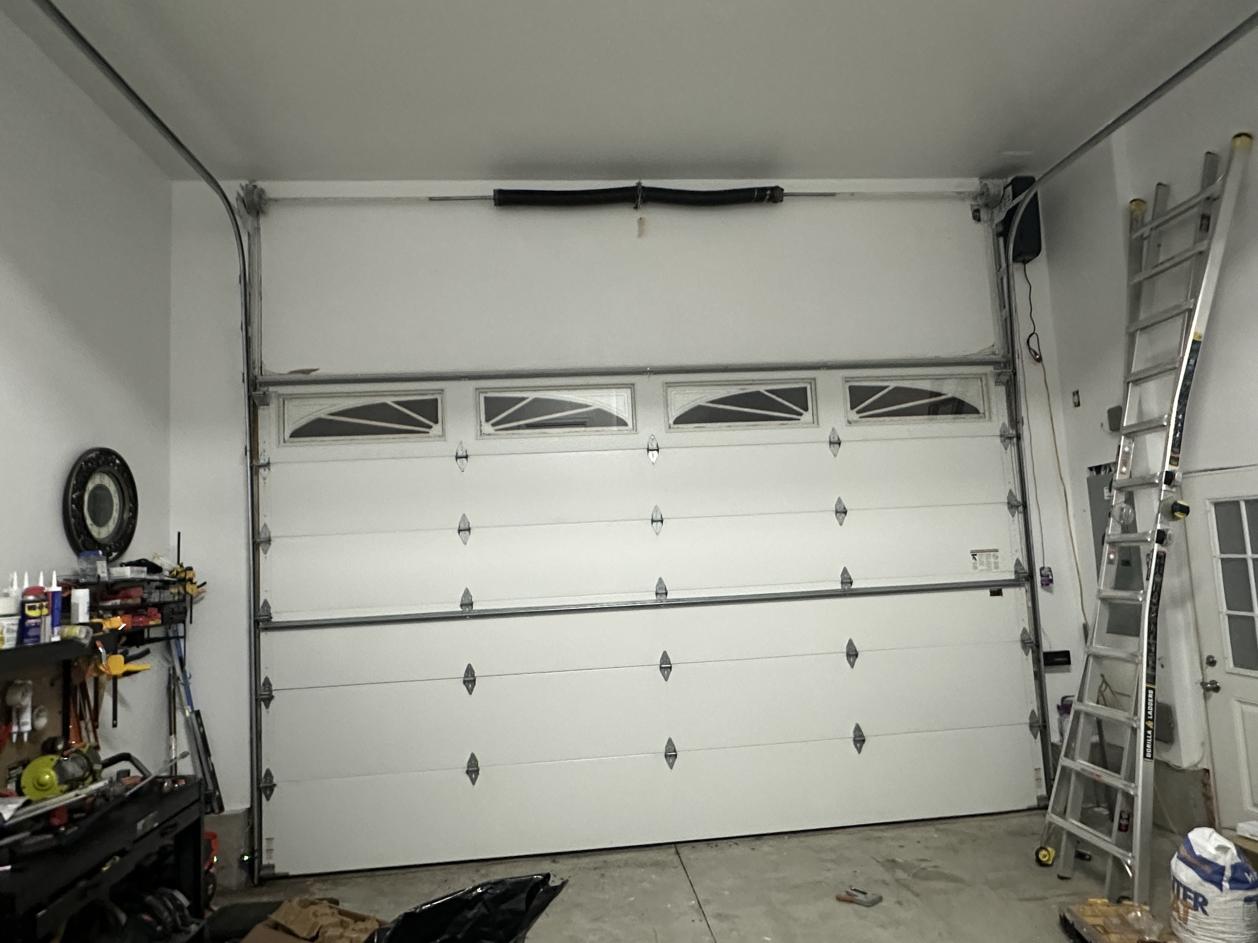 Newly installed white garage door on a Massachusetts home